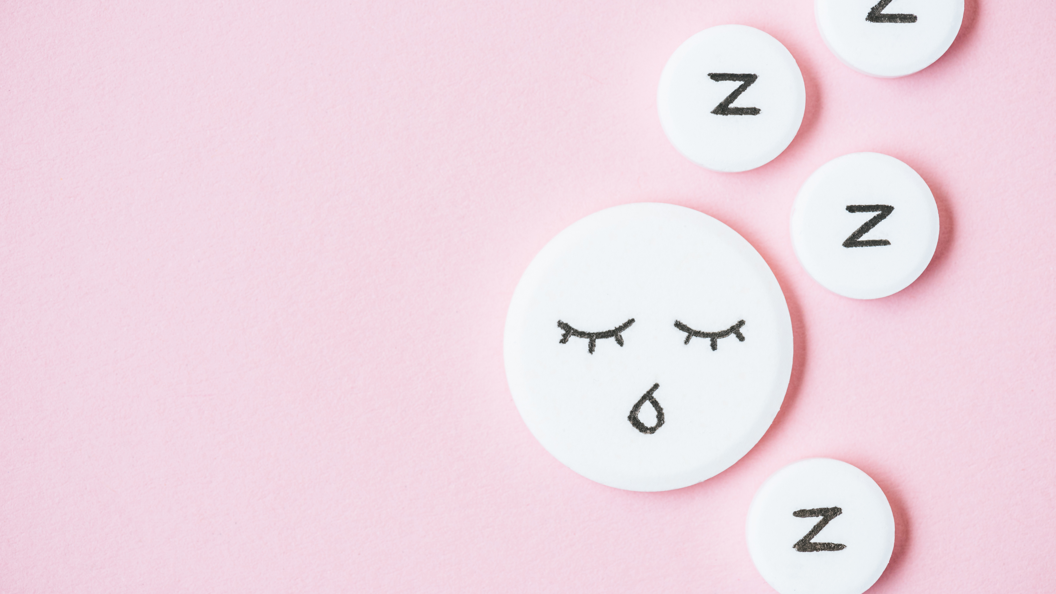 pink background with white circles with black z and black sleep emoji